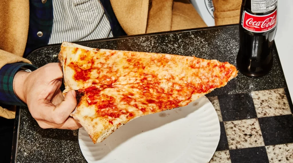 Fatia de pizza típica de Nova York, famosa pelo tamanho e sabor tradicional