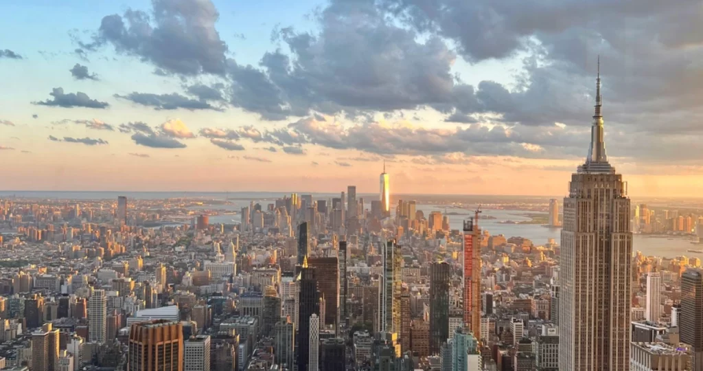 Vista do pôr do sol em Manhattan com o Empire State Building vista do Summit One New York.